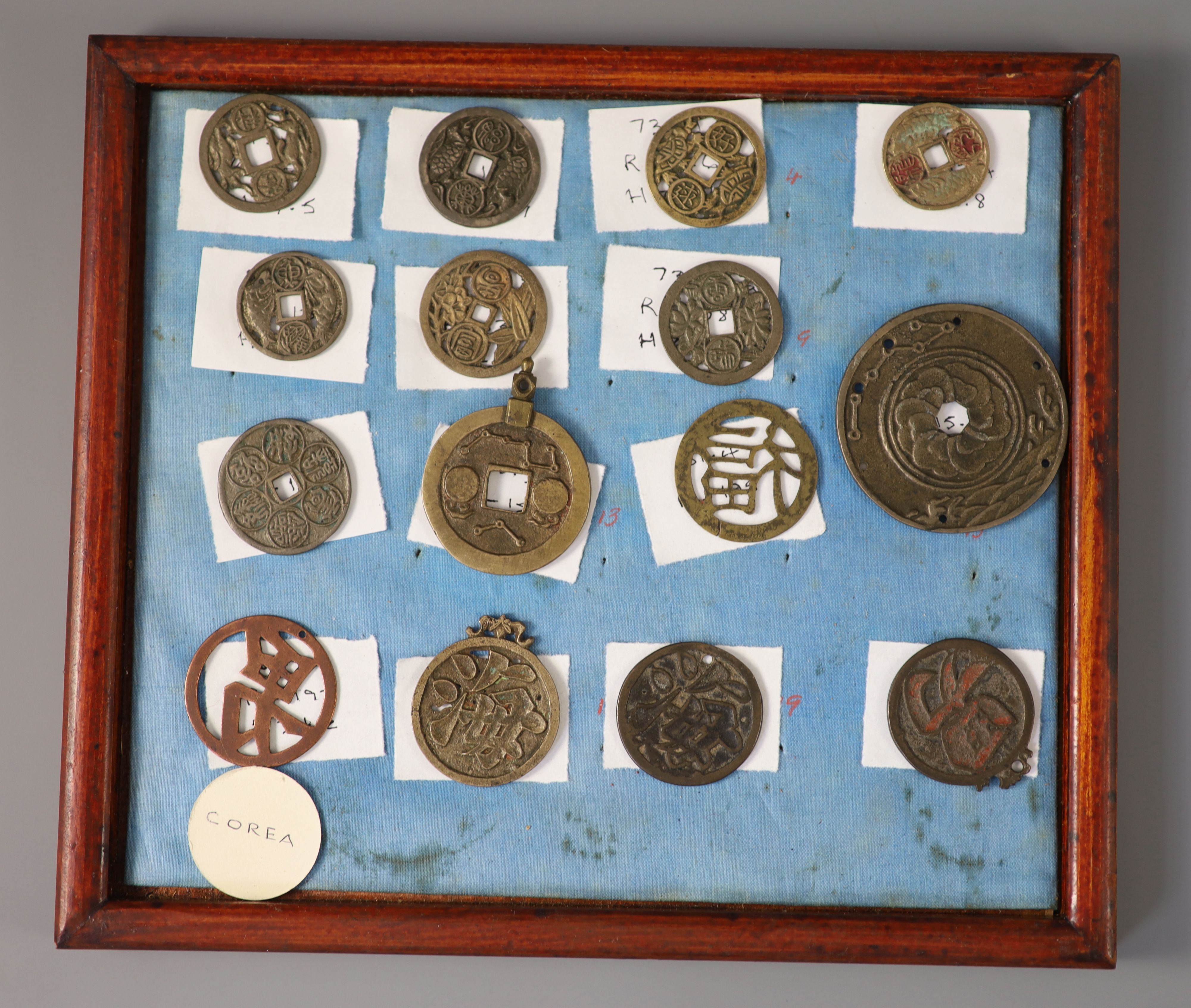 A group of 99 Korean bronze and metal amulets or charms, 19th/20th century